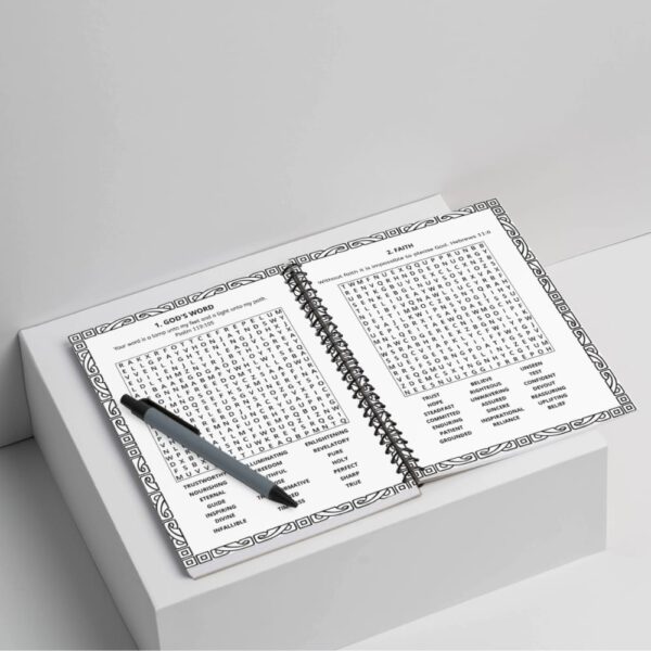Open spiral-bound bible word search with a pen on top of the left page