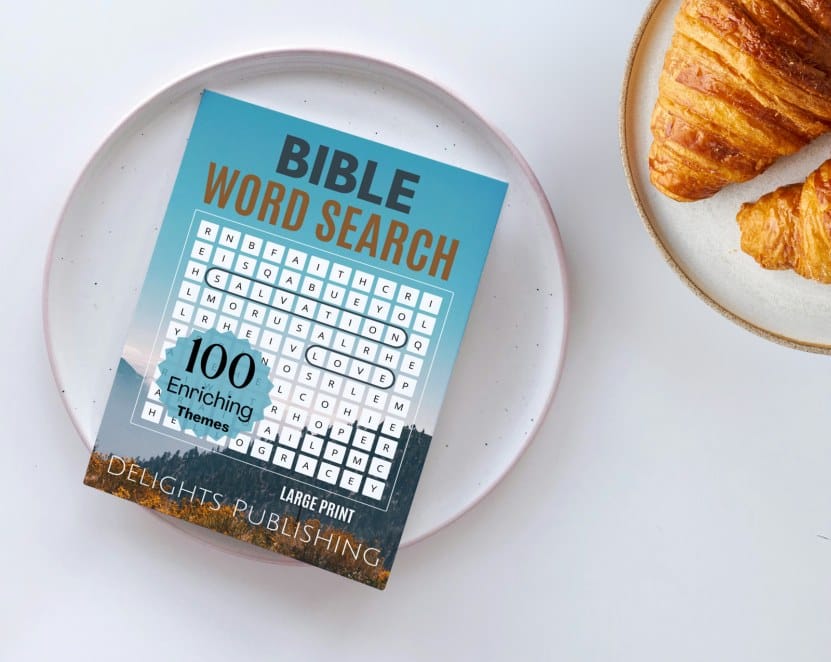 Home 3 A bible word search book on a plate next to a plate of croissant